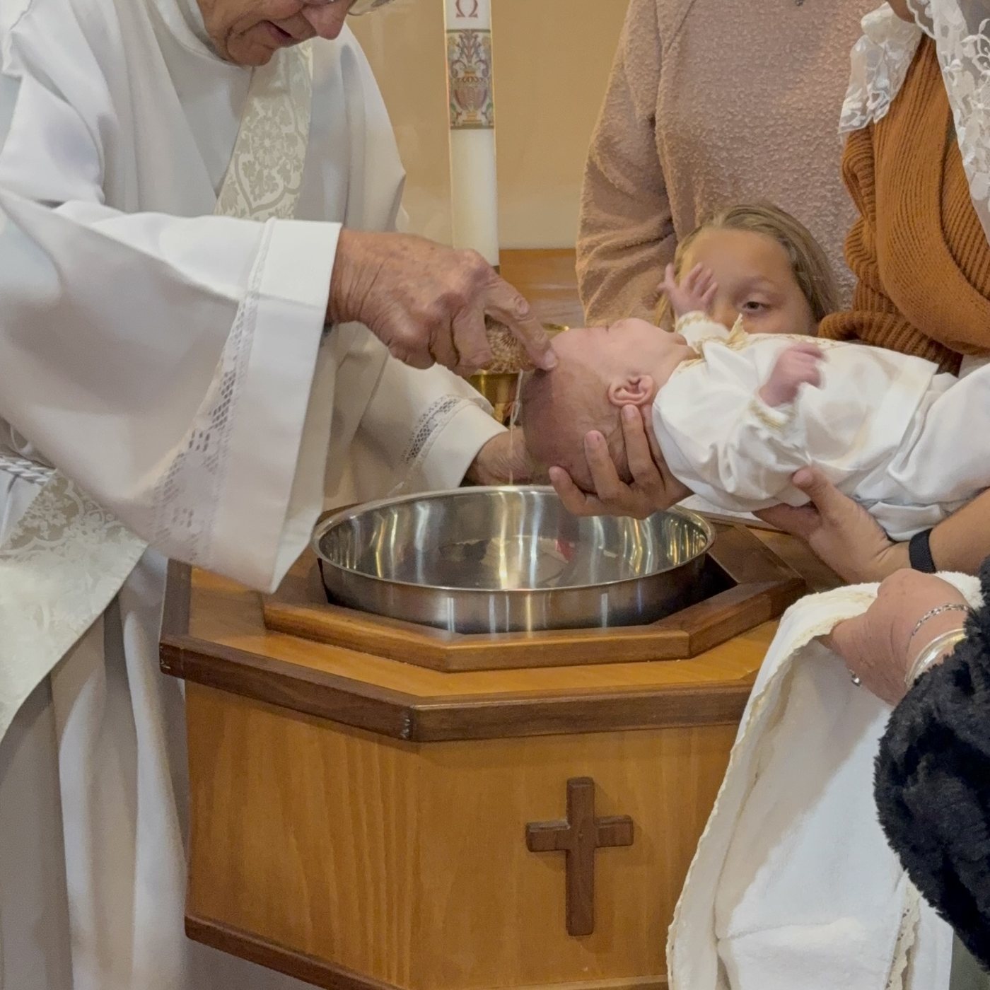 An infant receiving the Sacrament of Baptism at St. Ann Catholic Church