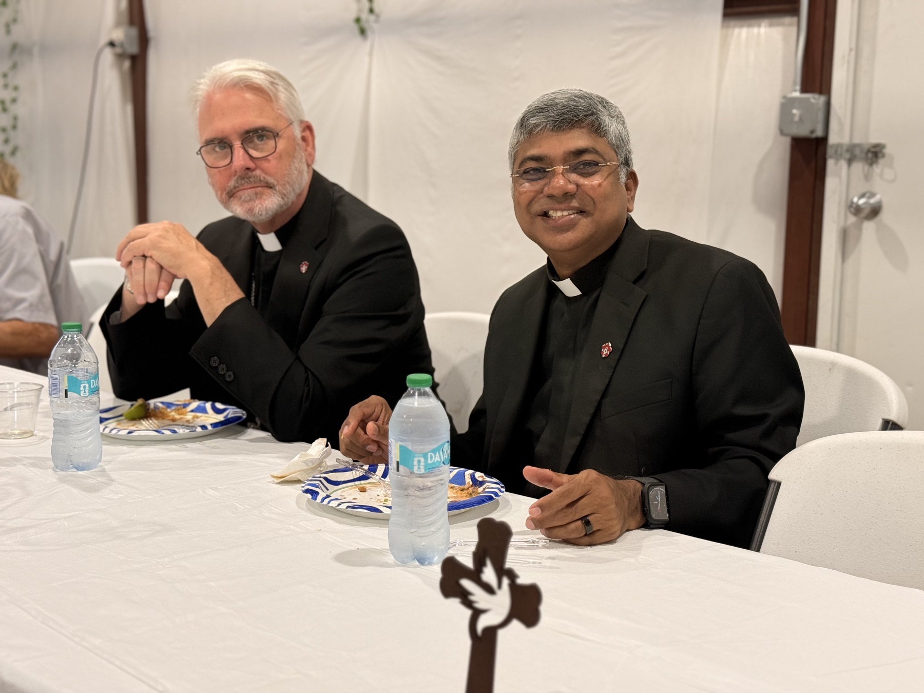 Archbishop Coakley and Father D seated together during the parish meal